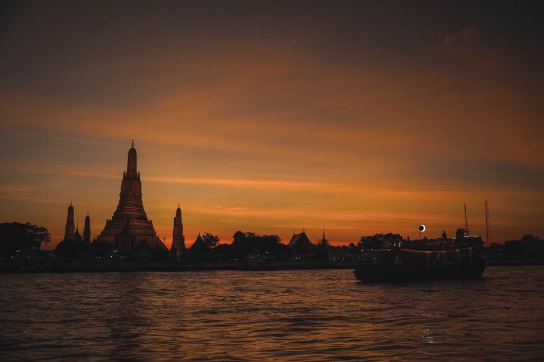 Wat Arun temple on the Chao Phraya river at sunset, Bangkok